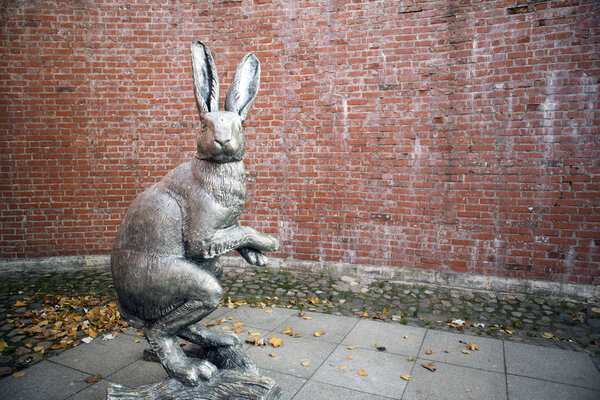 Saint-Petersburg, Russia, October 19, 2018. Grey plastic human height statue of hare against brick wall inside Peter and Paul fortress