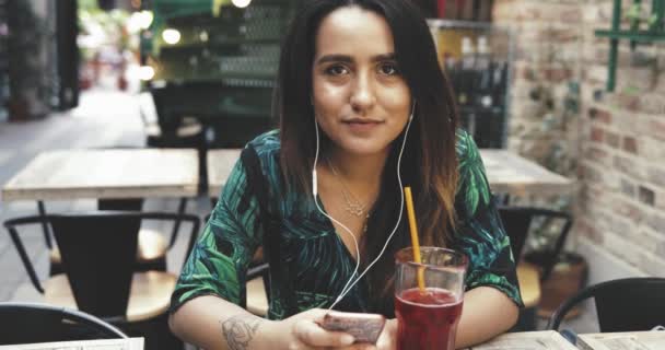 Young woman smiling as she reads a text message — Stock Video