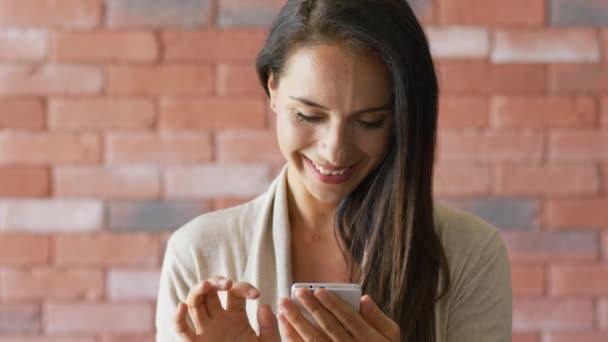 Sorrindo morena navegando smartphone moderno — Vídeo de Stock