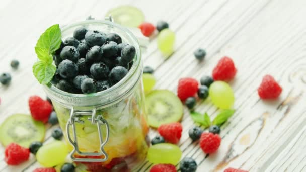 Jar filled with fresh berries — Stock Video