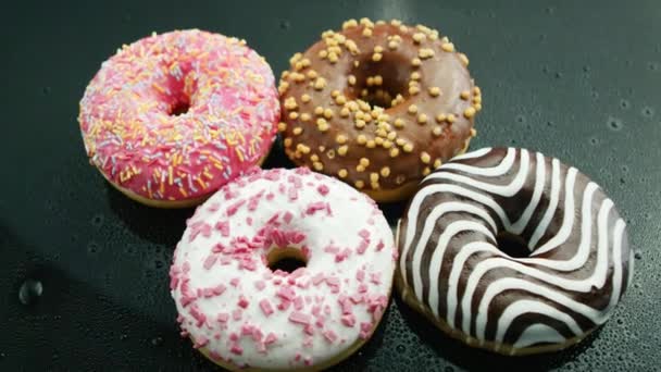 Delicious glazed doughnuts on glass — Stock Video