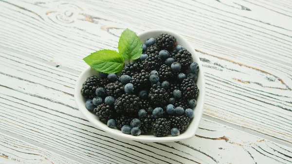 Heart shaped bowl with berries — Stock Photo, Image