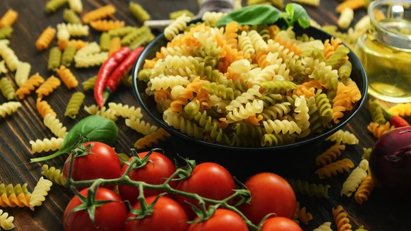 Bowl with raw macaroni of different color — Stock Photo, Image