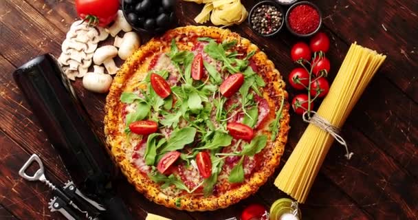Italian food background with pizza, raw pasta and vegetables on wooden table — Stock Video