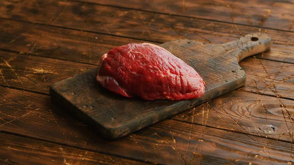 Potongan daging segar besar diletakkan di papan potong kayu — Stok Foto