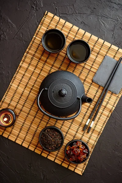 Asian green tea set on bamboo mat