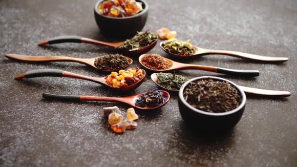 Spoons with different types of dry tea leaves. — Stock Video