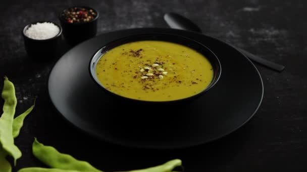 Creamy soup with green pea in a ceramic white plate — Stock Footage Creamy soup with green pea in a ceramic white plate Royalty Free Stock Footage