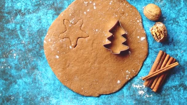 Christmas baking concept. Gingerbread dough with different cutter shapes — Stock Video
