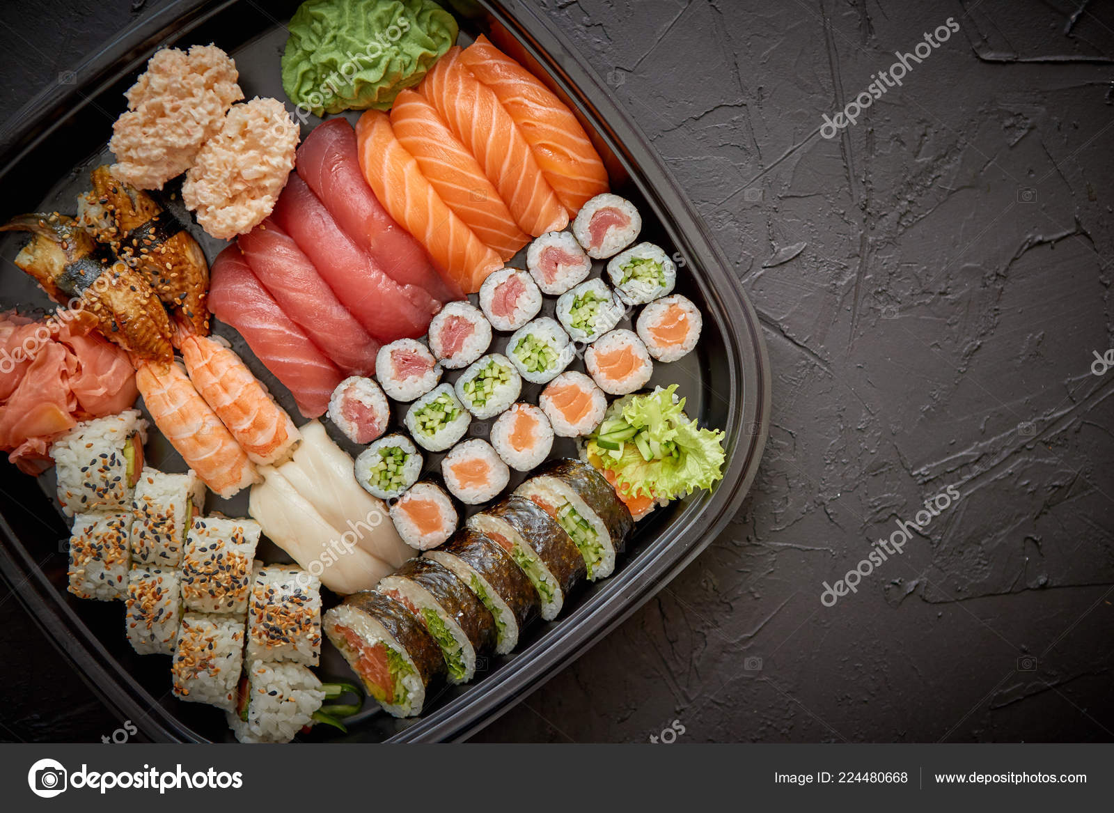 Sushi roll set with wasabi, ginger and soy sauce . Stock Photo by