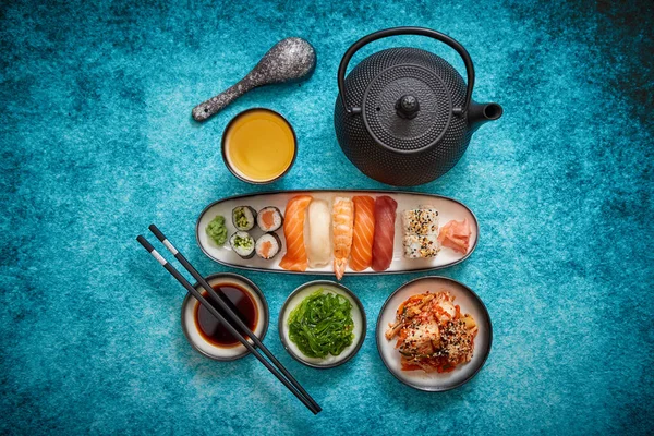Surtido de comida asiática. Varios rollos de sushi colocados en placas de cerámica — Foto de Stock
