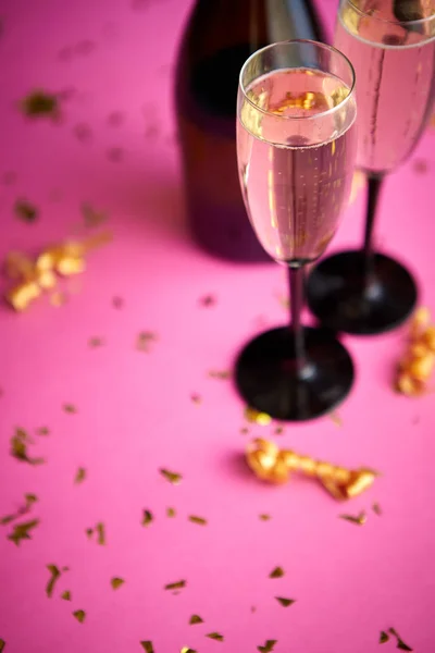 Botella y dos copas llenas de champán espumoso con decoración dorada — Foto de Stock