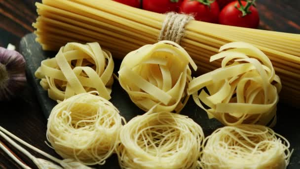 Dry pasta assortment on board — Stock Video