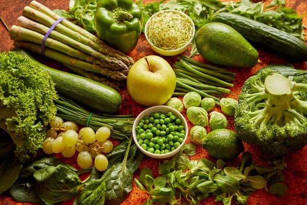 Fresh green vegetables and fruits assortment placed on a rusty metal — Stock Photo, Image