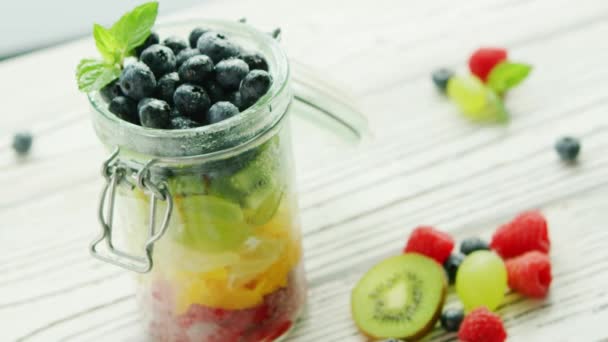 Jar filled with colorful fruit — Stock Video