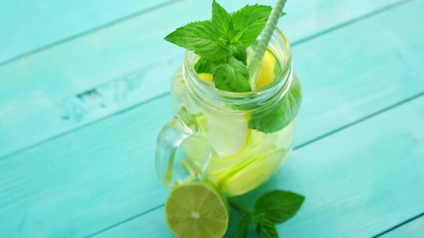 Refreshing lemonade on blue table — Stock Video