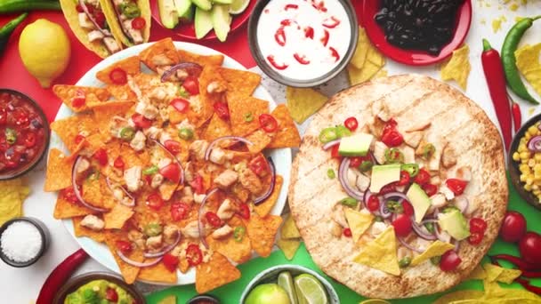 An overhead photo of an assortment of many different Mexican foods on a table — Stock Video