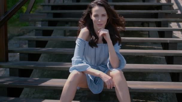 Rozkošná brunetka, která sedí na schodech venku — Stock video