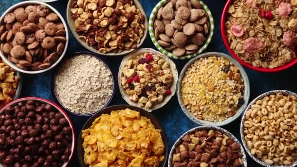 Assortment of different kinds cereals placed in ceramic bowls on table — Stock Video