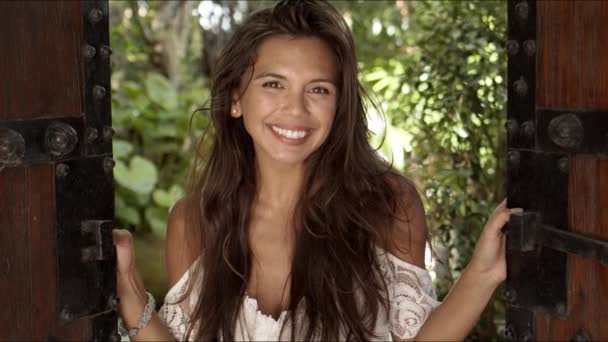 Joyful young woman standing in doorway — Stock Video