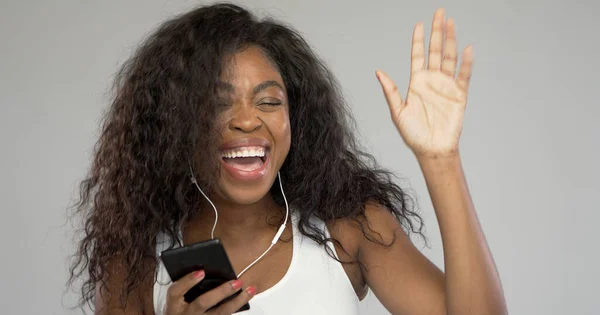 Felice donna etnica ascoltando musica e ballando — Foto Stock