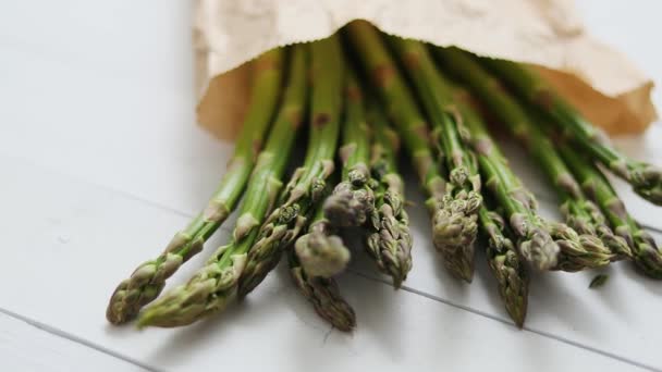 Färsk grön sparris i en brun papperspåse. Hälsosam kost koncept. Livsmedel för vegetarianer — Stockvideo