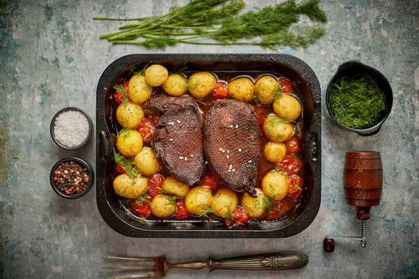 Dada angsa panggang lezat disajikan dengan sayuran, kentang. Ditempatkan di logambaking piring — Stok Foto