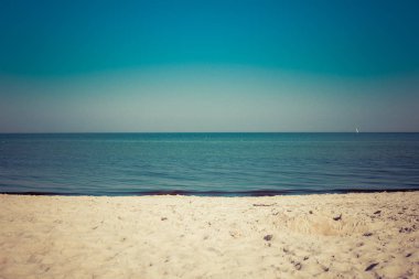 Yaz yatay, kumlu ve boş plaj sakin deniz üzerinde