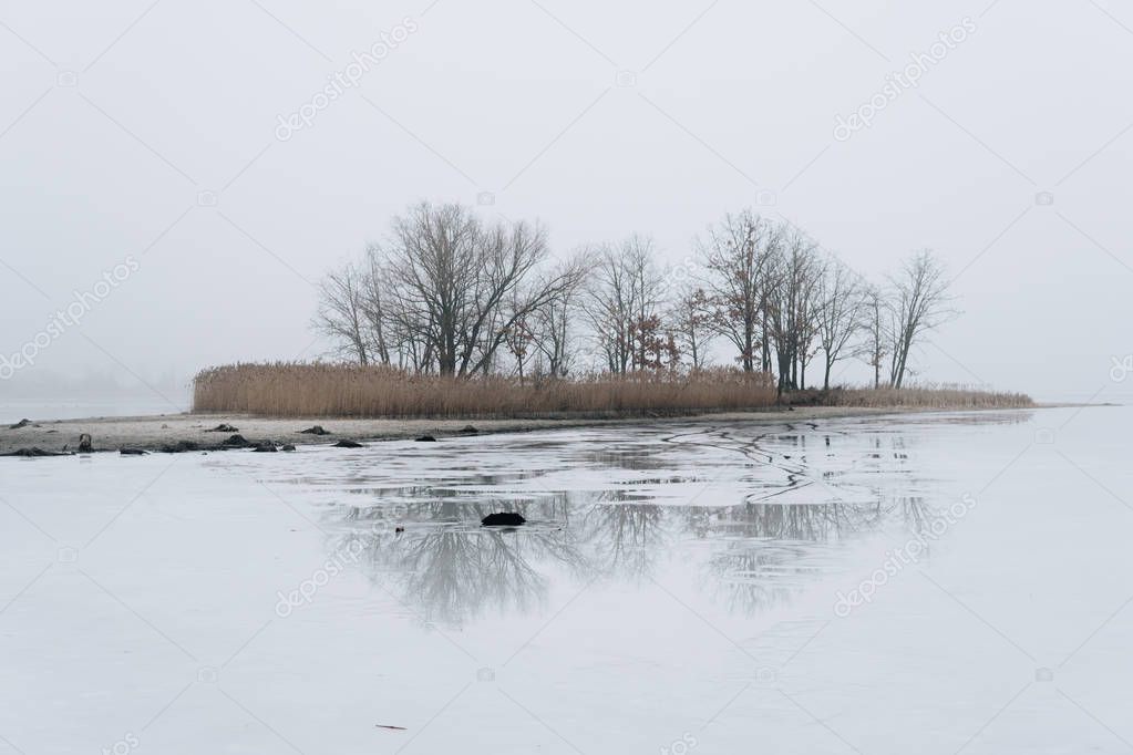 island on ice covered lake