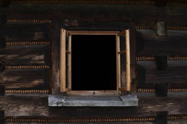 Eski bir evin ahşap duvarındaki eski pencereler.