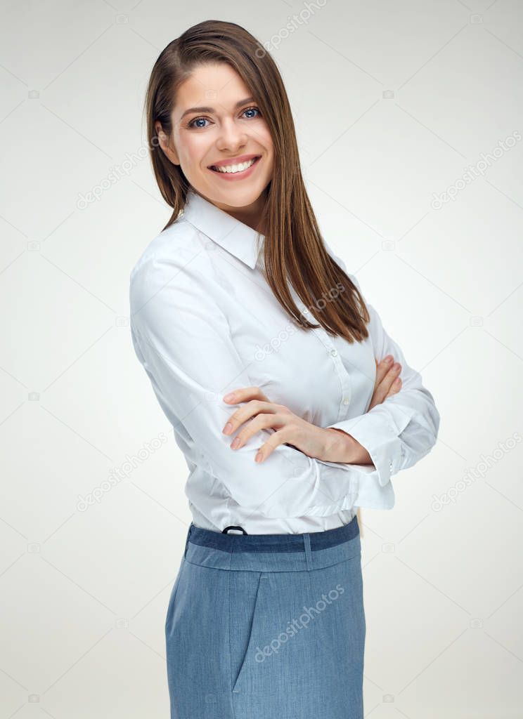 Smiling businesswoman wearing white shirt standing with crossed arms isolated on white background