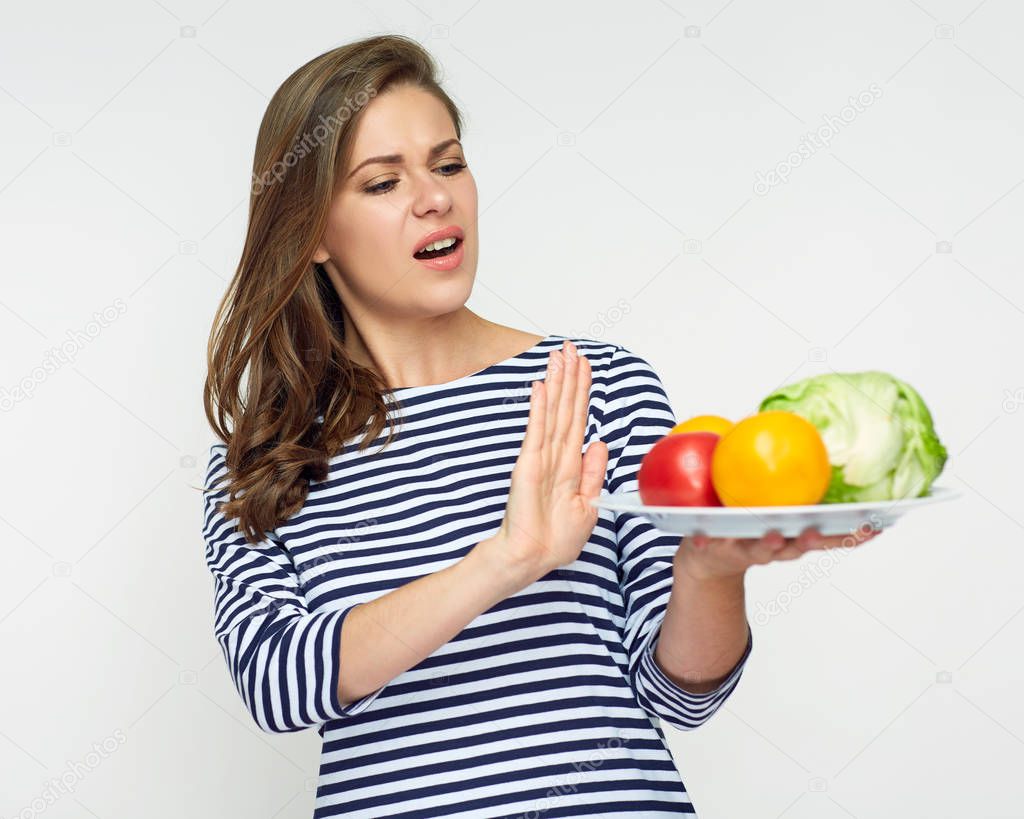 unhappy woman holding plate with vegetables isolated on white background, diet concept 