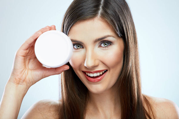 portrait of young woman holding jar face anti wrinkles cream