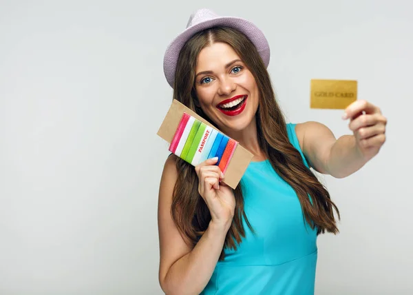 Happy woman holding passport with credit card, concept of travel