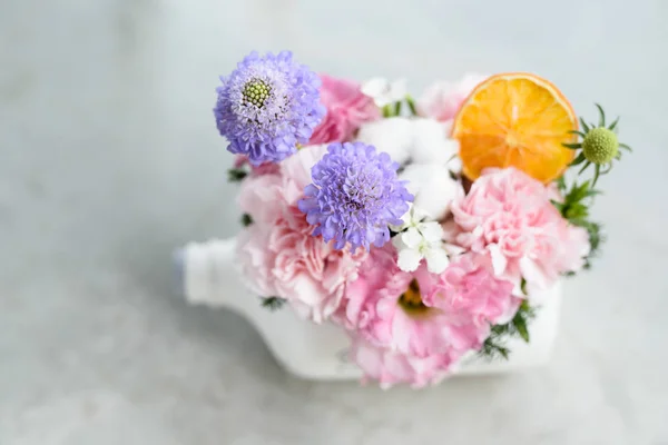 Beautiful flowers and tree potted in white bottle pot Stock Image