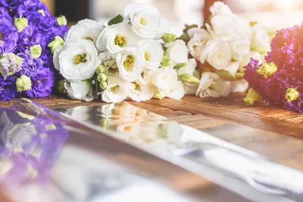 Purple and white flowers on table with reflection Royalty Free Stock Photos