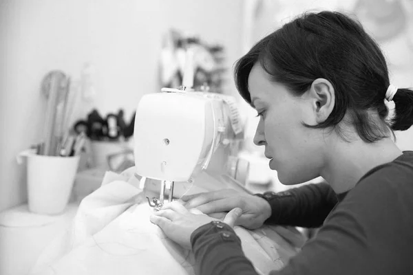 Young woman tailoring in her own small business crafting atelier