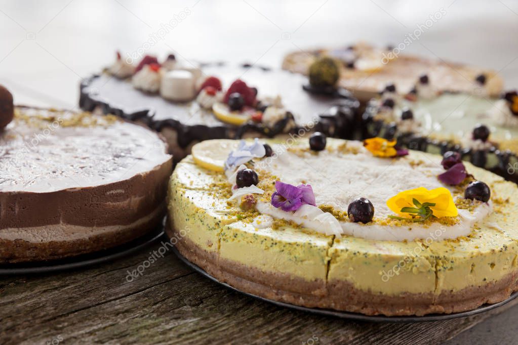 Delicious raw vegan cakes with lovely decorations on it.