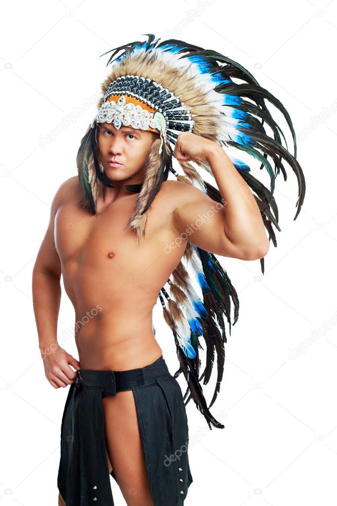 handsome muscular young man wearing a Native American costume