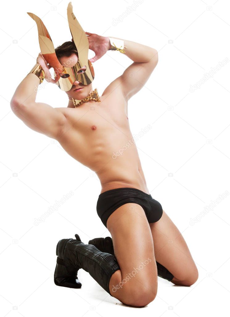 striptease dancer wearing underwear and face mask with rabbit ears in the studio isolated against white background