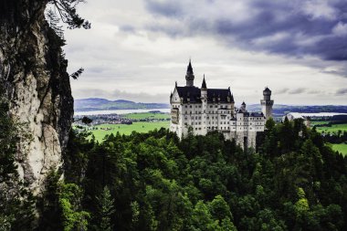 Neuschwanstein castle in Germany in summertime on a coudy day clipart