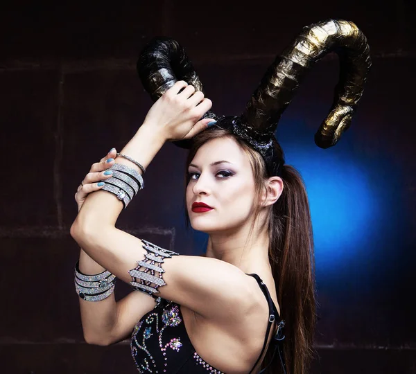 Beautiful dancer wearing leather and horns — Stock Photo, Image