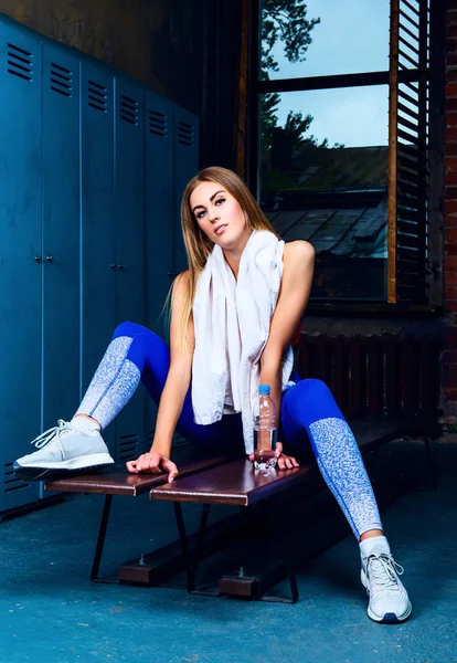 Woman in the locker room after working out — Stock Photo, Image