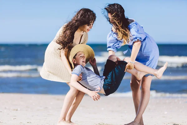 Two Women Carrying Boy Straw Hat Beach Family Playtime Bonding — Stock Photo, Image