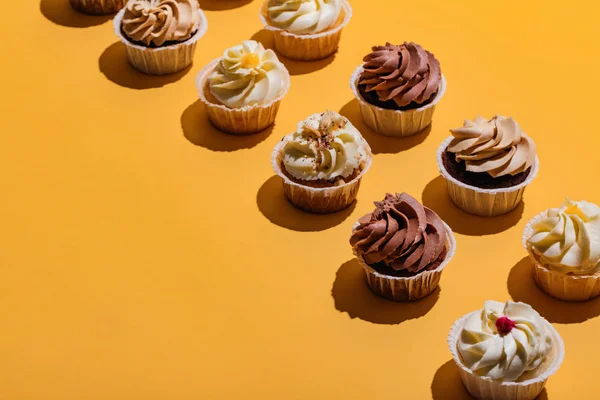 Cupcakes Sárga Háttéren Ízletes Kezeli — Stock Fotó