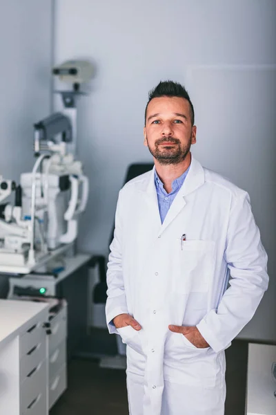 stock image Doctor standing confident in his office, exam room. Optician