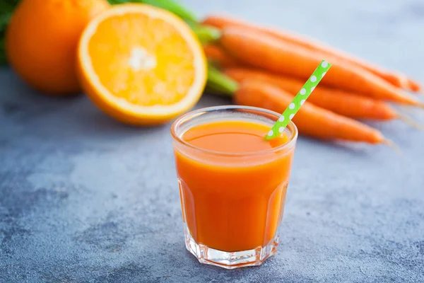 Glas Med Färskpressad Juice Och Morötter Med Apelsiner Grå Bakgrund — Stockfoto