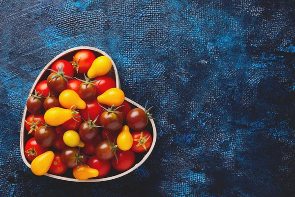fresh delicious tomatoes in heart shaped bowl