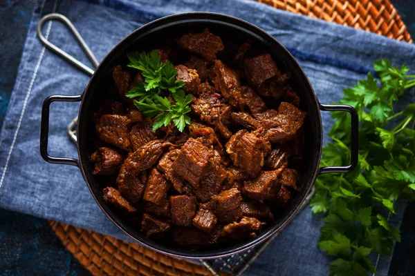 stock image jug of goulash beef stew with herbs - food and drink