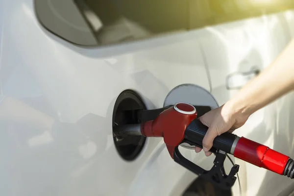 stock image the girl runs the car at the gas station. close up